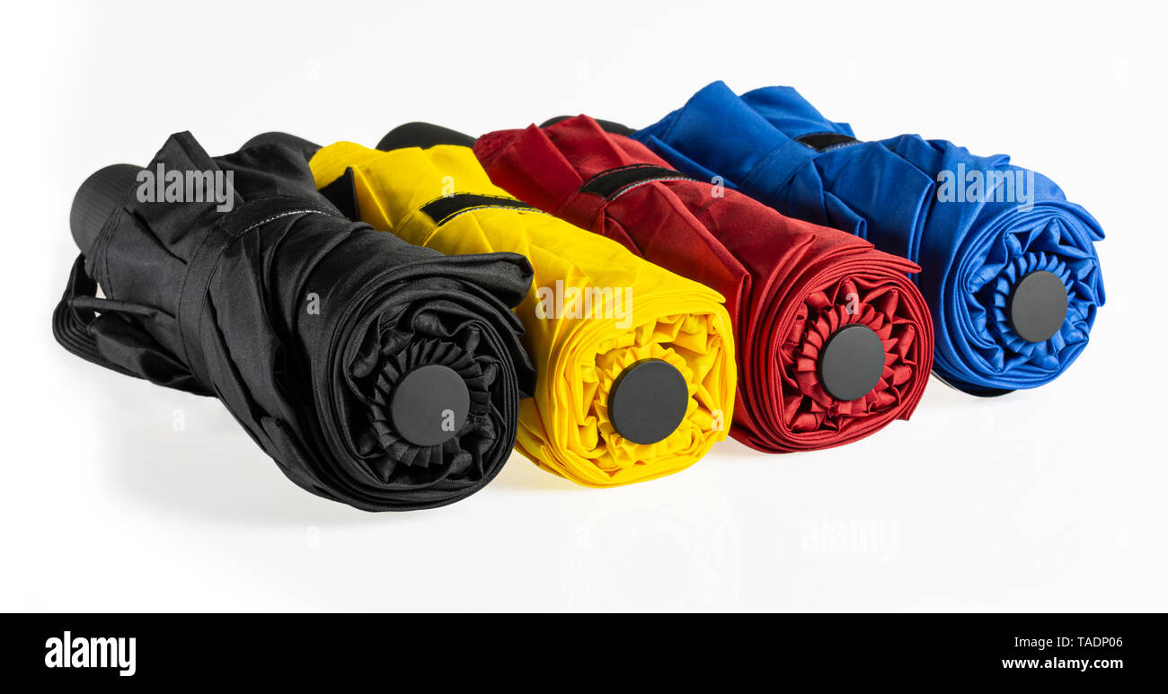 Multicolored compact umbrellas isolated on white Stock Photo