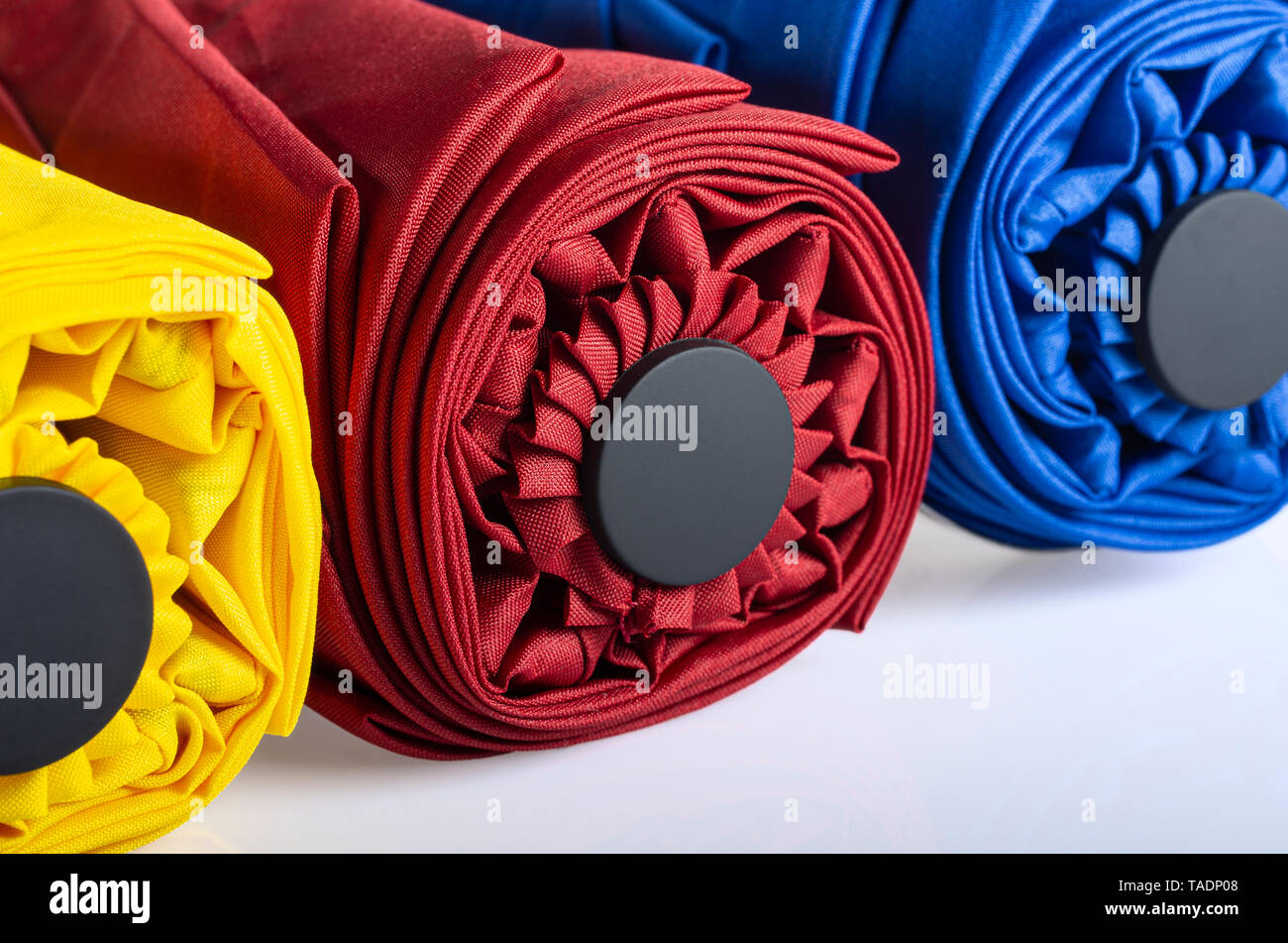 Multicolored compact umbrellas isolated on white Stock Photo
