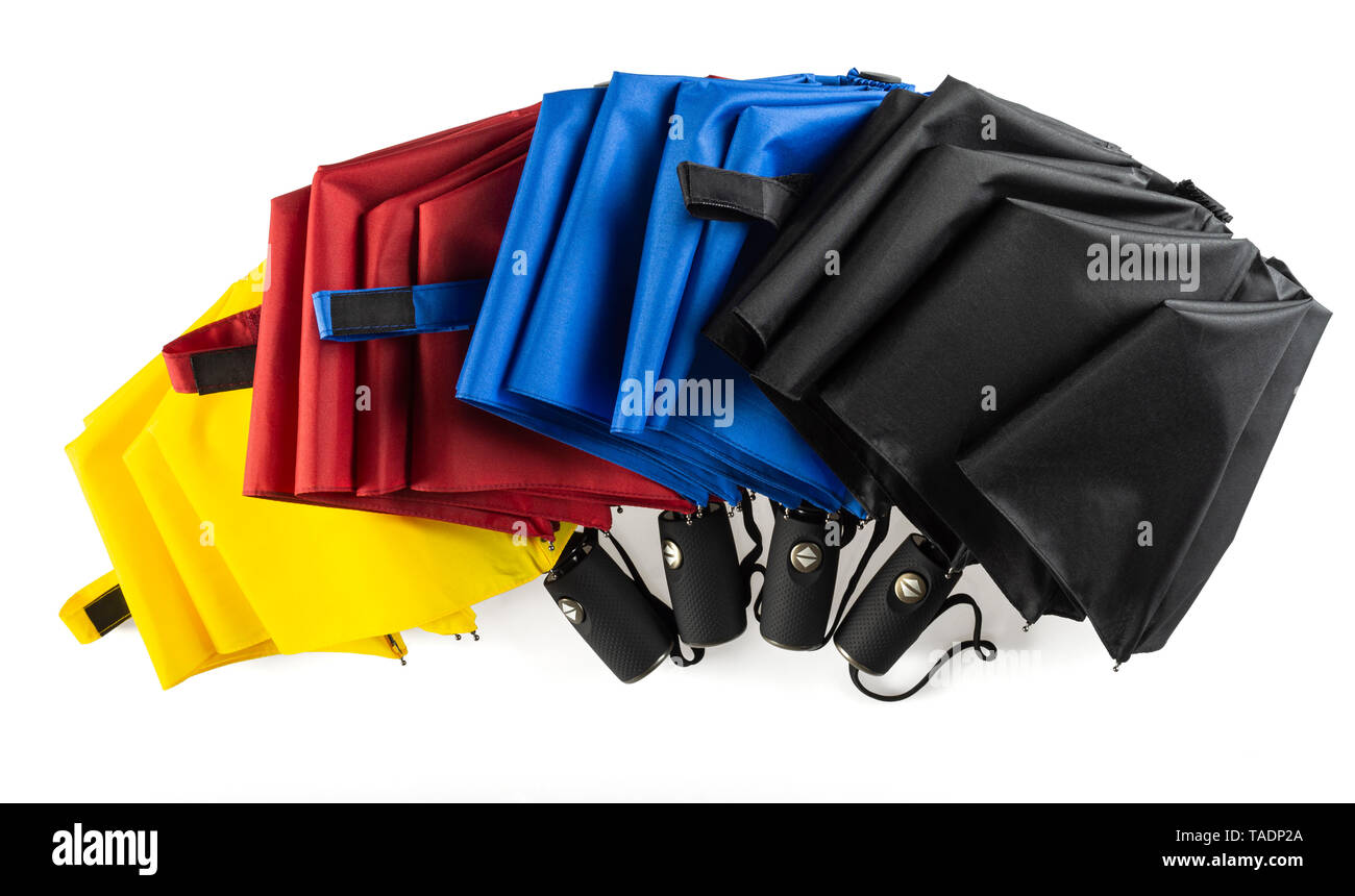 Multicolored unfolded compact umbrellas isolated on white Stock Photo