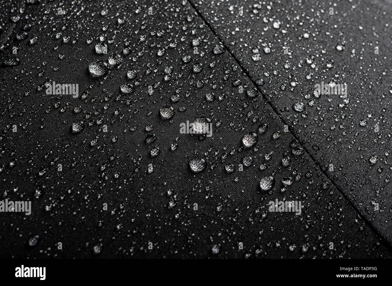 Black waterproof umbrella texture with water droplets Stock Photo