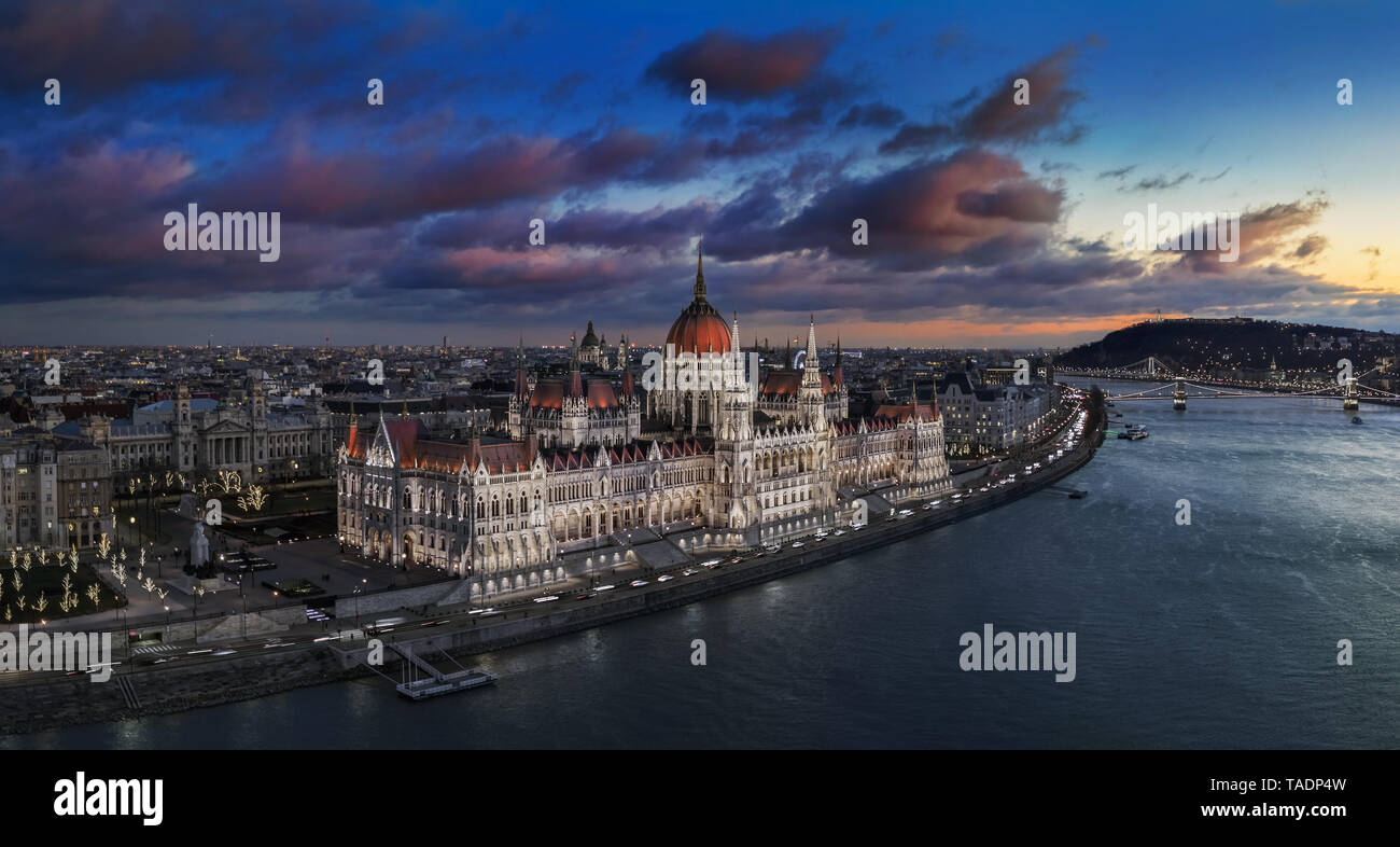 Budapest, Hungary - Aerial panoramic view of the beautiful illuminated Parliament of Hungary with Szechenyi Chain Bridge, Statue of Liberty and colurf Stock Photo
