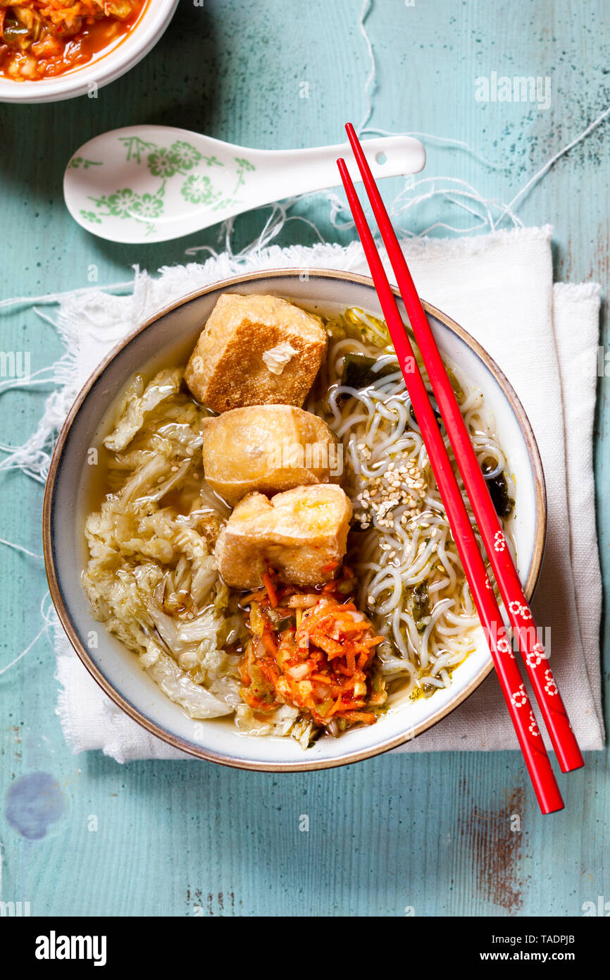 Asian noodle soup with cabbage, tofu, shirataki noodles and homemade kimchi Stock Photo