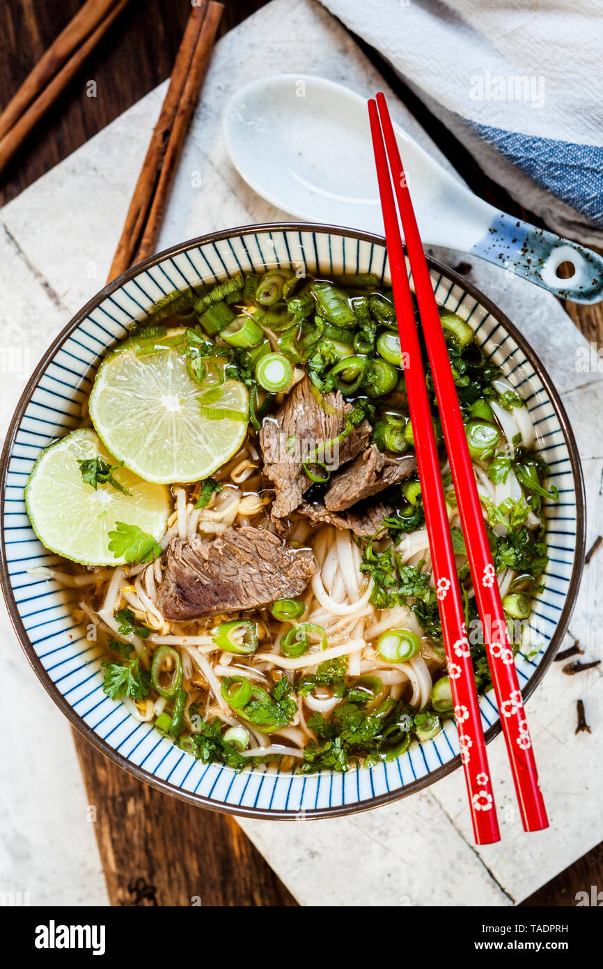 Bowl of Vietnamese Pho with rice noodles, mung beans, cilantro, spring