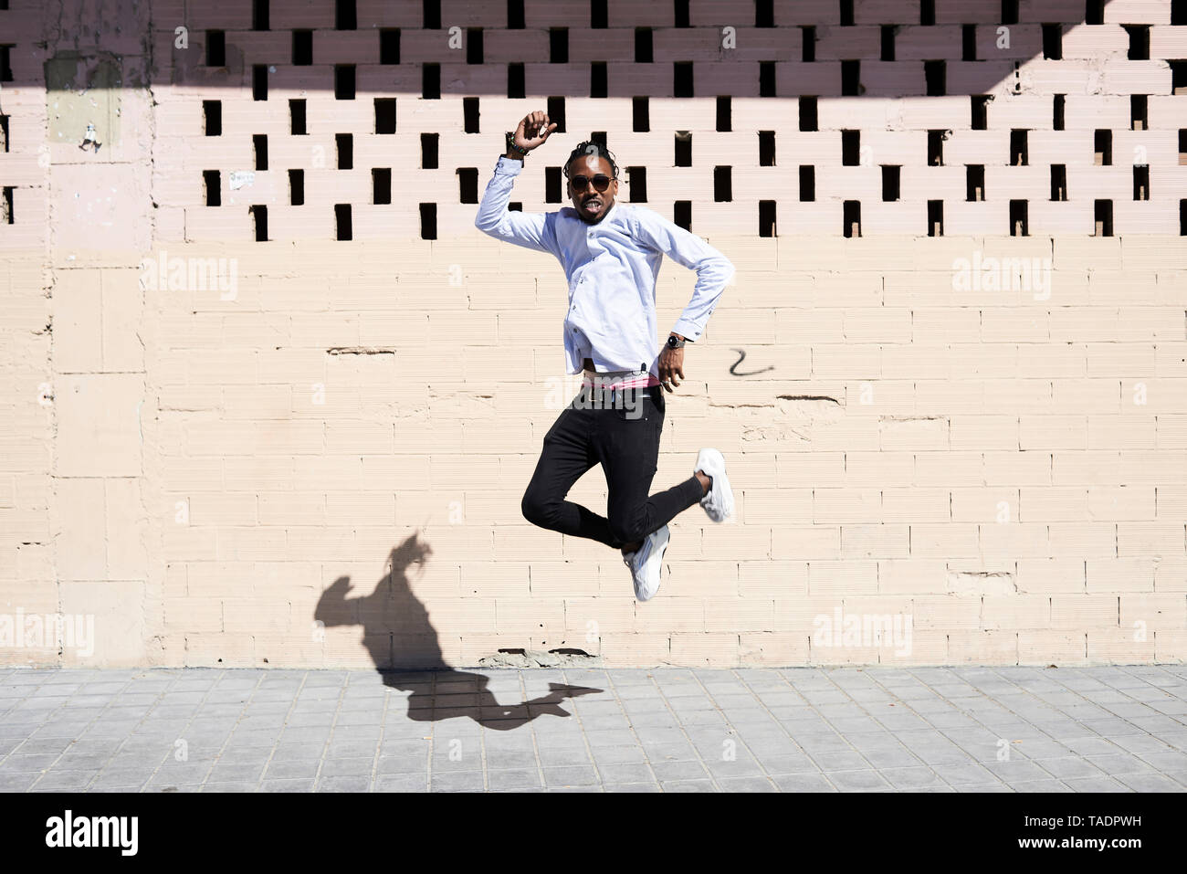 Happy young man jumping in the air Stock Photo