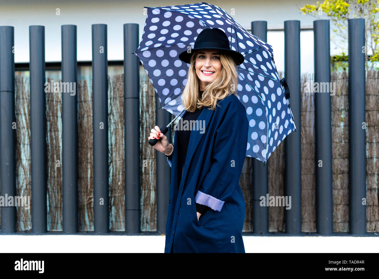Blond woman with umbrella on a rainy day Stock Photo