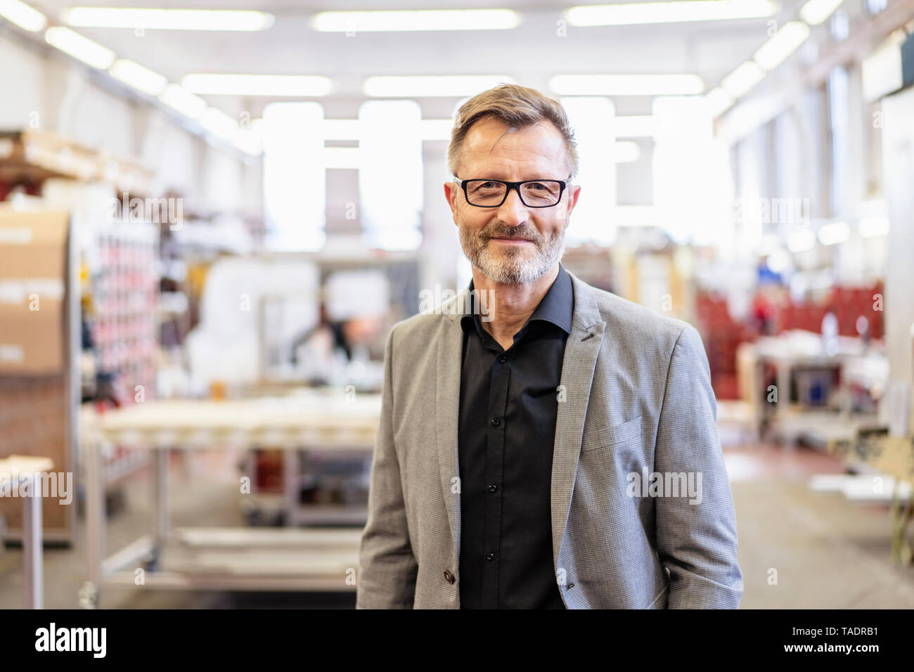 Portrait of confident businessman in factory Stock Photo