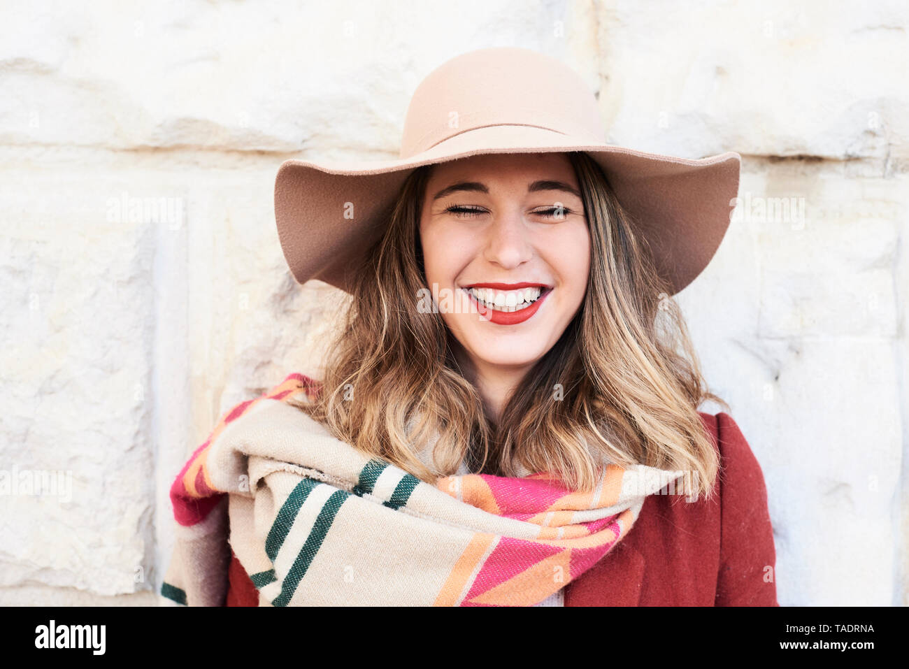 Portrait of a happy stylish woman wearing a floppy hat Stock Photo