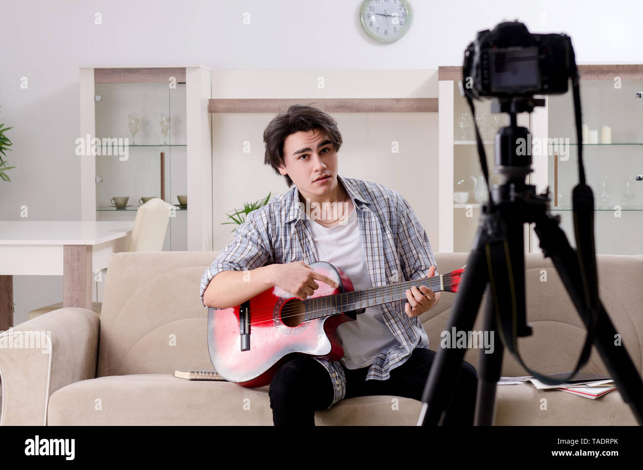 Young guitar player recording video for his blog Stock Photo
