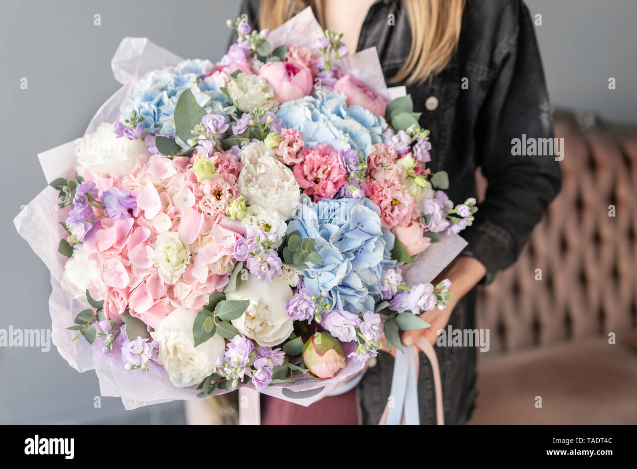 Large Beautiful bouquet of mixed flowers in woman hand. Floral shop