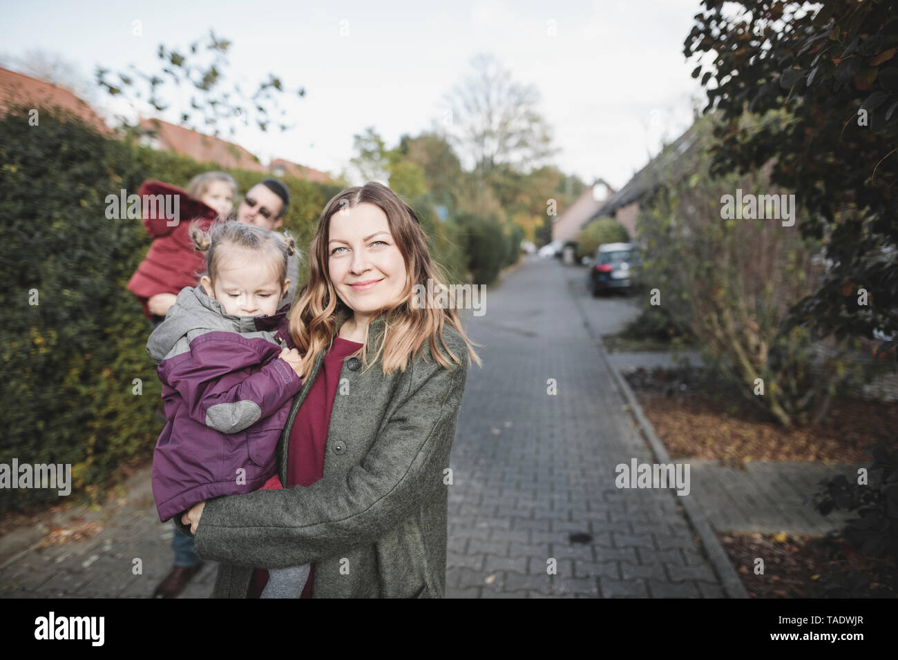 Portrait of family on path in residential area Stock Photo