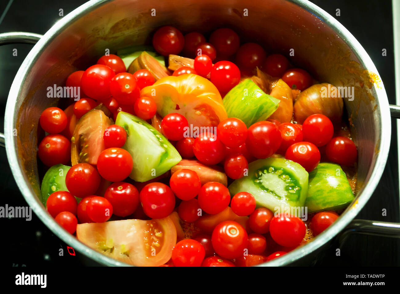 Pile of various tomato sorts in a pot Stock Photo