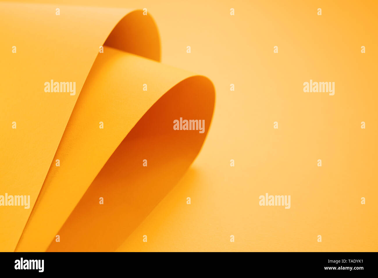 Orange folded papers as background Stock Photo