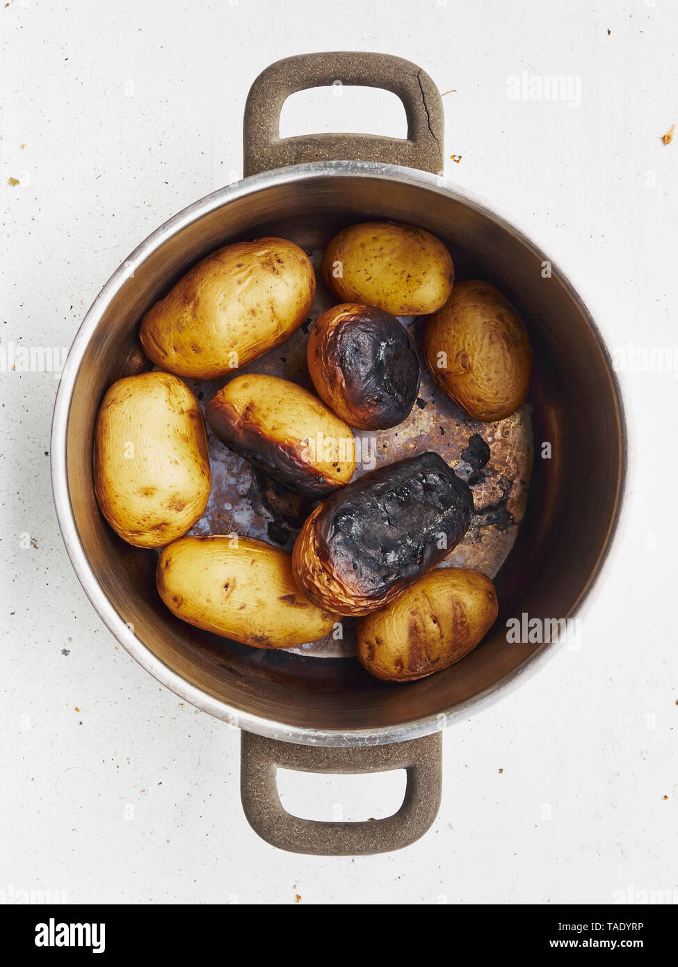 Cooking pot of burnt potatoes Stock Photo