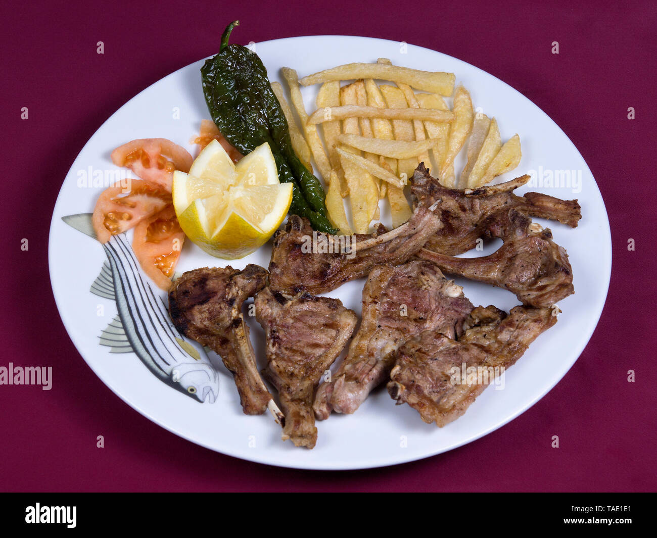 Grilled lamb chops in fish dish Stock Photo Alamy