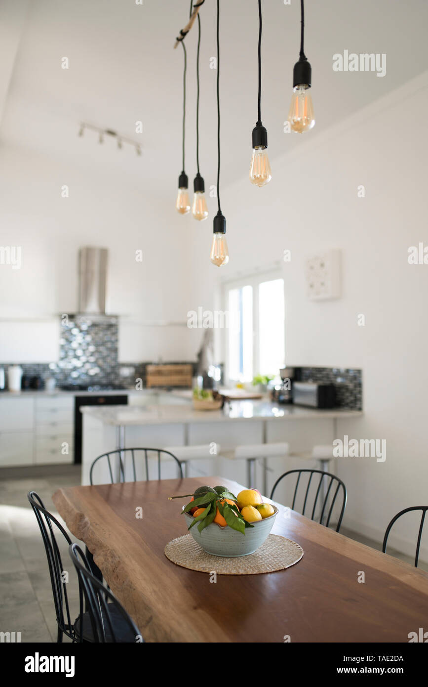 Modern kitchen with wooden table Stock Photo - Alamy