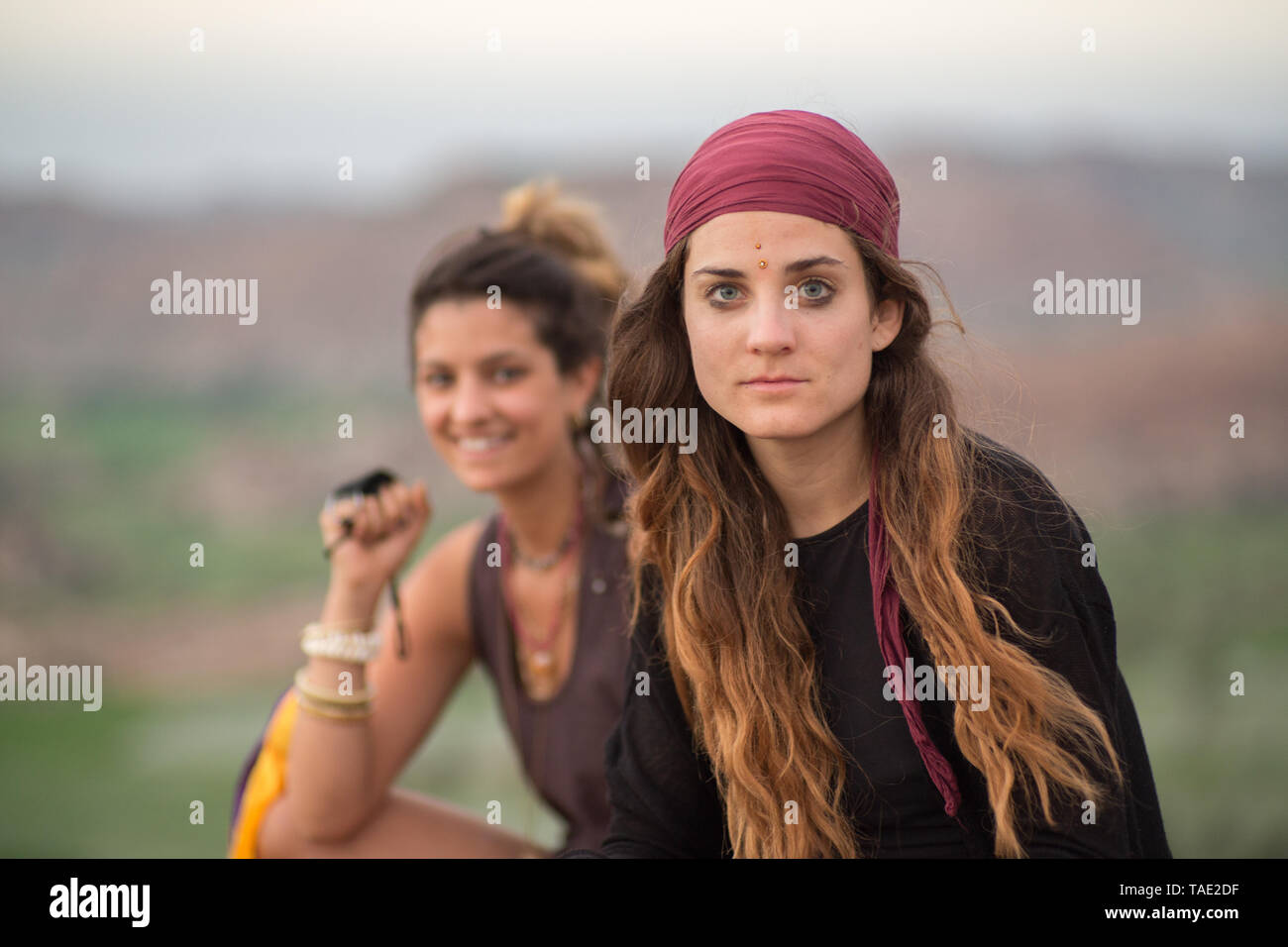 Two beautiful hippie girls at sunset Stock Photo