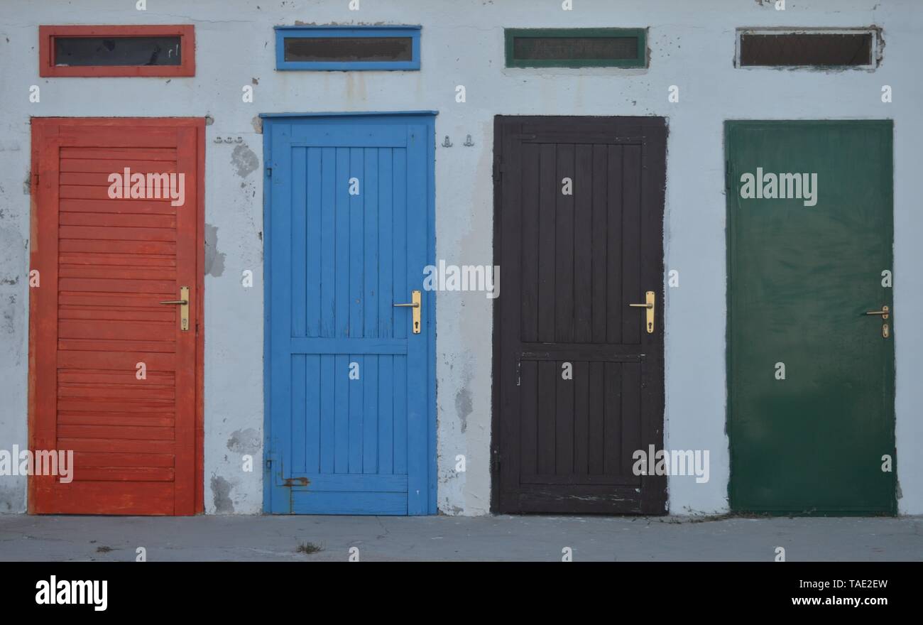 Cabin doors in different colors, white wall Stock Photo Alamy