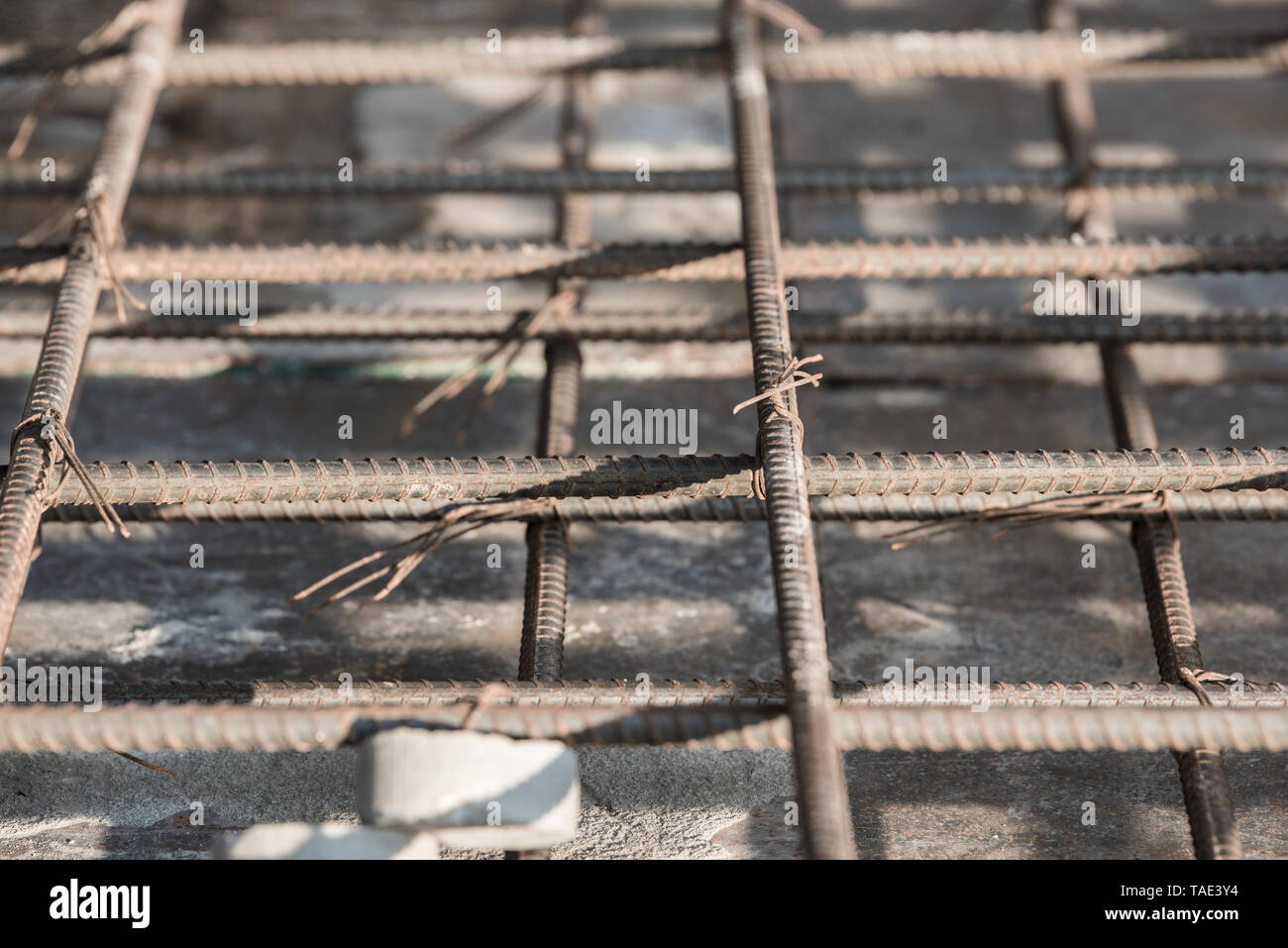 Using steel wire for securing steel bars with wire rod for reinforcement of concrete slab or focus to steel wire. Stock Photo