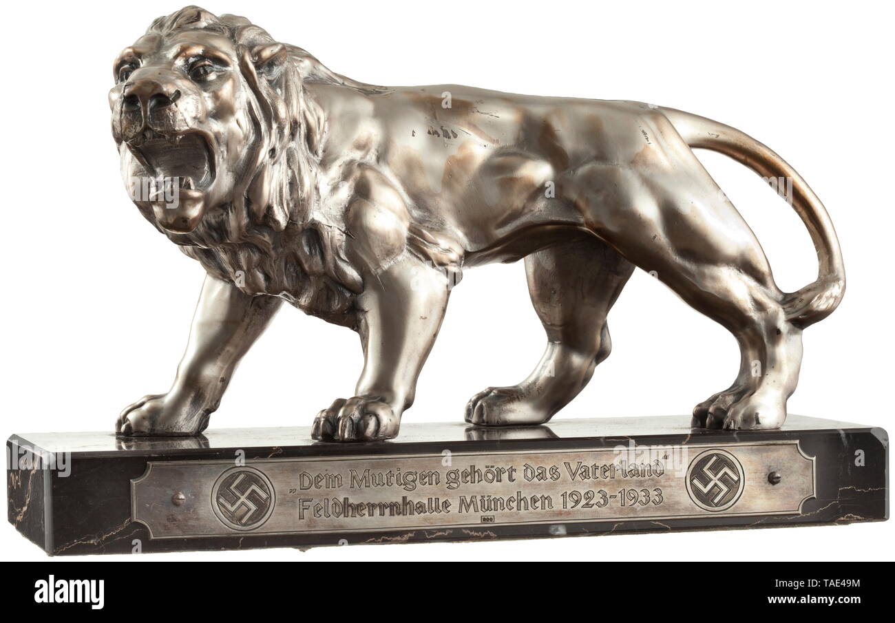 SA-Obersturmführer Josef Eichbauer (1903 - 1944) - an honorary gift for the "Blutorden" bearer commemorating the 10th anniversary of the Feldherrnhalle March Silver-plated roaring lion on red-streaked black marble base. On face side engraved silver dedication badge "Dem Mutigen gehört das Vaterland - Feldherrnhalle München 1923-1933" between two swastika disks, hallmarked "800". Dimensions circa 16.5 x 26.5 x 10 cm. historic, historical, 20th century, 1930s, 1940s, storm battalion, stormtroopers, armed and uniformed branch of the NSDAP, organisation, organization, organizat, Editorial-Use-Only Stock Photo
