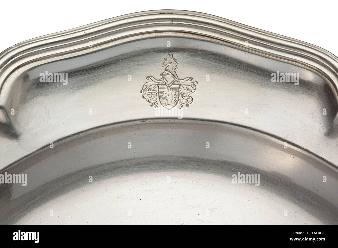 A silver plate formerly owned by Count Zeppelin (1883 - 1917) Crafted by the jeweller to the court Foehr in Stuttgart. Banded edge with relief decoration, on the border the coat of arms of the von Zeppelin family. The jeweller's mark 'Foehr' and mark of fineness '800' stamped into the base. Diameter 24 cm. Weight 500 g. historic, historical, troop, troops, armed forces, military, militaria, army, wing, group, air force, air forces, 20th century, Editorial-Use-Only Stock Photo