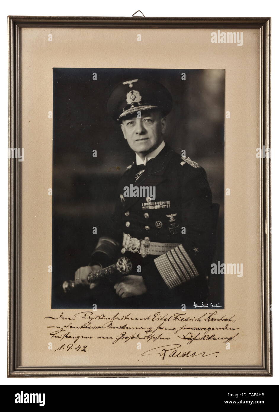 Knight's Cross bearer, corvette captain and commander of U-74 Eitel-Friedrich Kentrat - an honour plate of the U-Boat Force on the award of the Knight's Cross and an inscribed portrait from Erich Raeder White glazed porcelain plate manufactured by Meissen (sword mark), the blue décor depicting the awards of WWI and WWII submarine commanders on a laurel wreath and dedicated in yellow-gold to 'Herrn Korvettenkapitän Kentrat'. Reverse marked with 'N11Z' and the enrolment number '135'. Diameter 25.3 cm. Together with a presentation portrait with inscription by Großadmiral Raede, Editorial-Use-Only Stock Photo