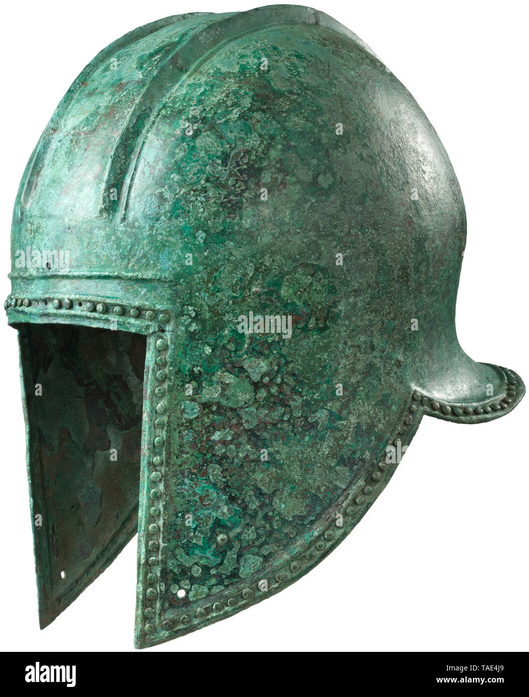 An Illyrian helmet of middle form (type II), late 7th - mid 6th century BC Bronze helmet with straight facial cut-out, the integral cheek-pieces extending straight downwards, rising to the back in an elegant curve and terminating into pointed side cut-outs which slope to a flaring horizontal neckguard. The entire lower edge of the helmet decorated with a dense row of 4.5 mm wide studs set between a double rib in repoussé. About ancient world, Additional-Rights-Clearance-Info-Not-Available Stock Photo