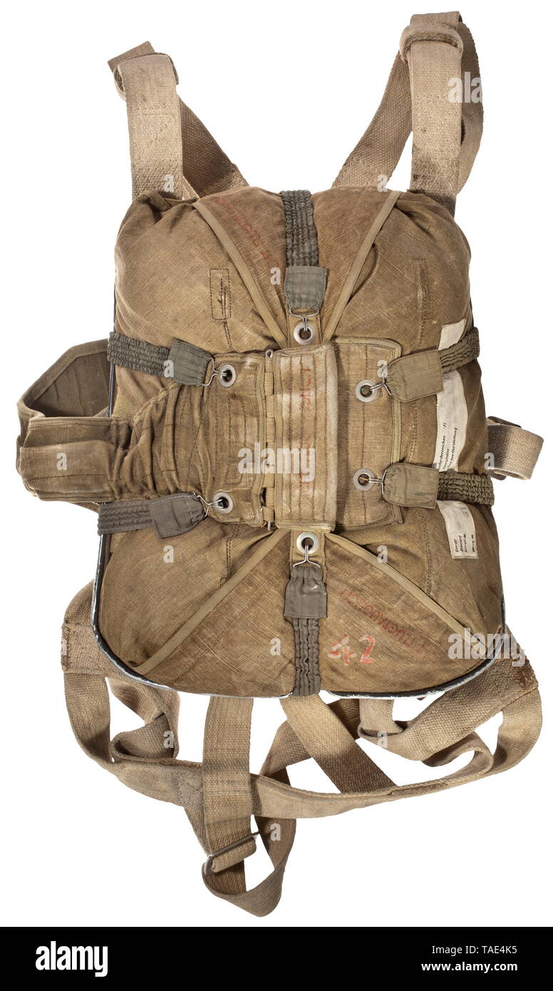 A backpack parachute RH 12B (RüFa 12B) complete with back shell and harness White silk canopy packed in an olive-coloured linen sack, thus completeness and condition are not verifiable. Stitched label 'Bauart: Autoflug Berlin, Gerätnr:... Rüfa 12 B, Anforderzeichen: FL 80245 - 1, Hersteller: Richard von Kehler & Sohn G.m.b.H...' with an illegible date 30 December 1941(?). Riveted, olive-green painted aluminium back shell with retracted harness of light linen with stitched label 'Fallschirmgurt... Rüfa 12 B... Richard von Kehler...', six spanning straps with green synthetic , Editorial-Use-Only Stock Photo