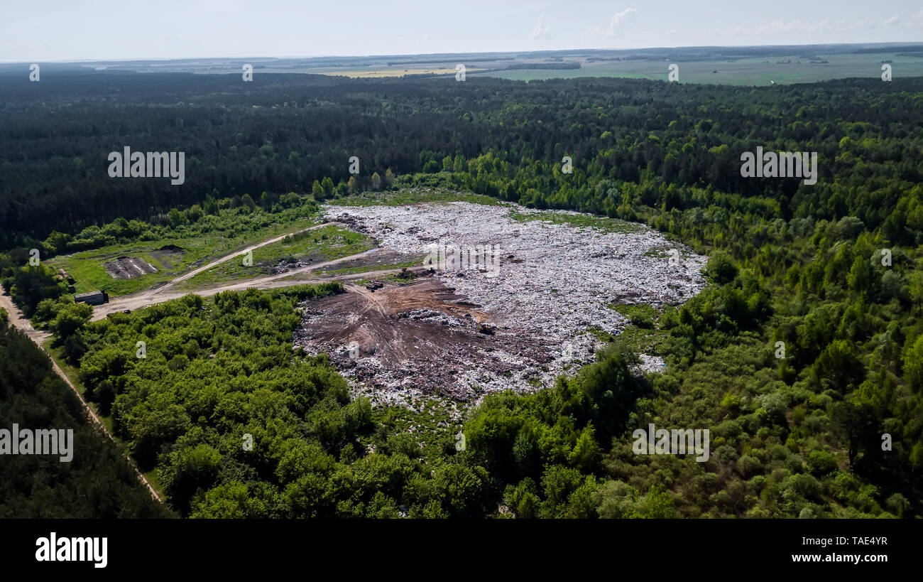 landfill removal of unsorted debris in the middle of the forest. Aerial photography with drone Stock Photo