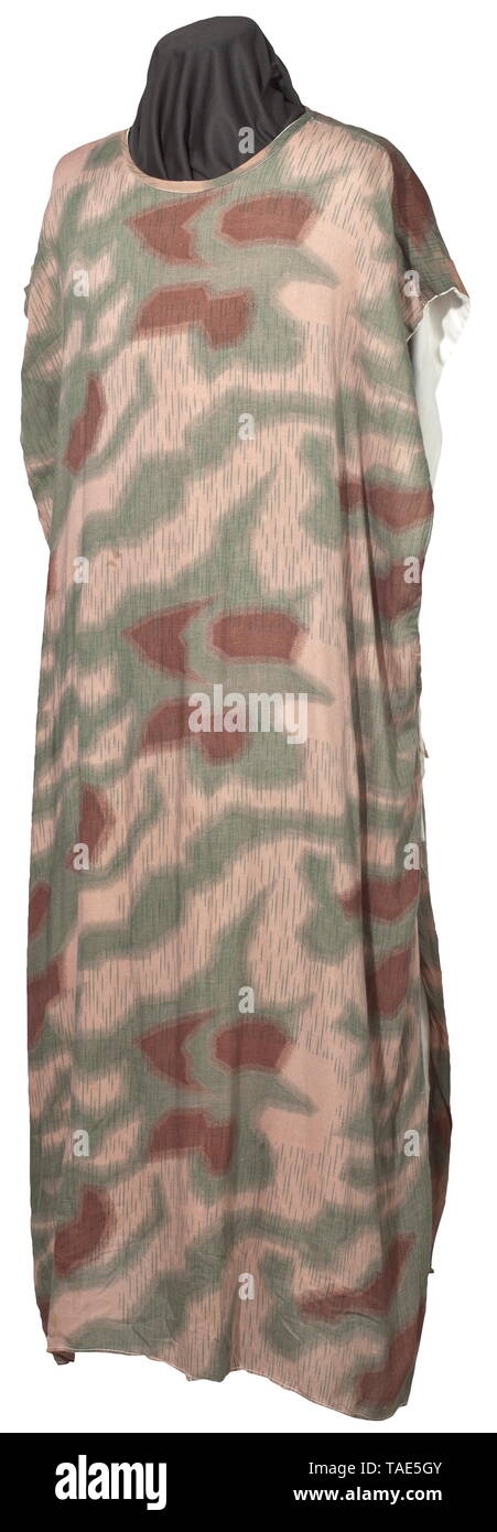 A reversible camouflage cloak for snipers Imprinted material in marsh camouflage with a sewn-in (defects) white reverse side, straight cut with securing bands on the open sides. Colour fresh. historic, historical, army, armies, armed forces, military, militaria, object, objects, stills, clipping, clippings, cut out, cut-out, cut-outs, 20th century, Editorial-Use-Only Stock Photo