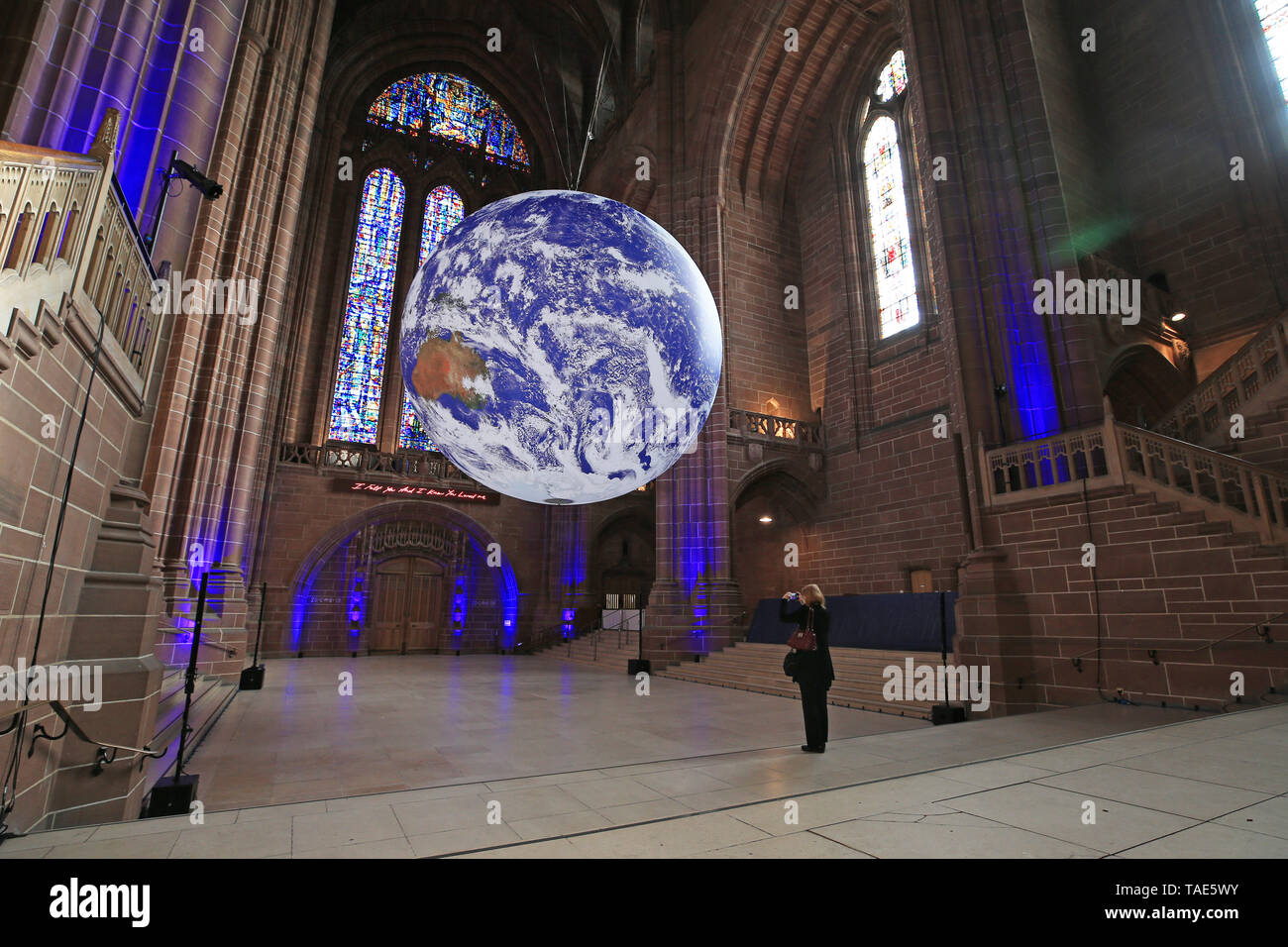 Gaia, a 23ft replica of planet earth hangs on display inside Liverpool Cathedral ahead of the city's River festival. The large installation, created by British artist Luke Jerram, features accurate and detailed imagery from NASA and is on display for the first time anywhere in the world. Stock Photo
