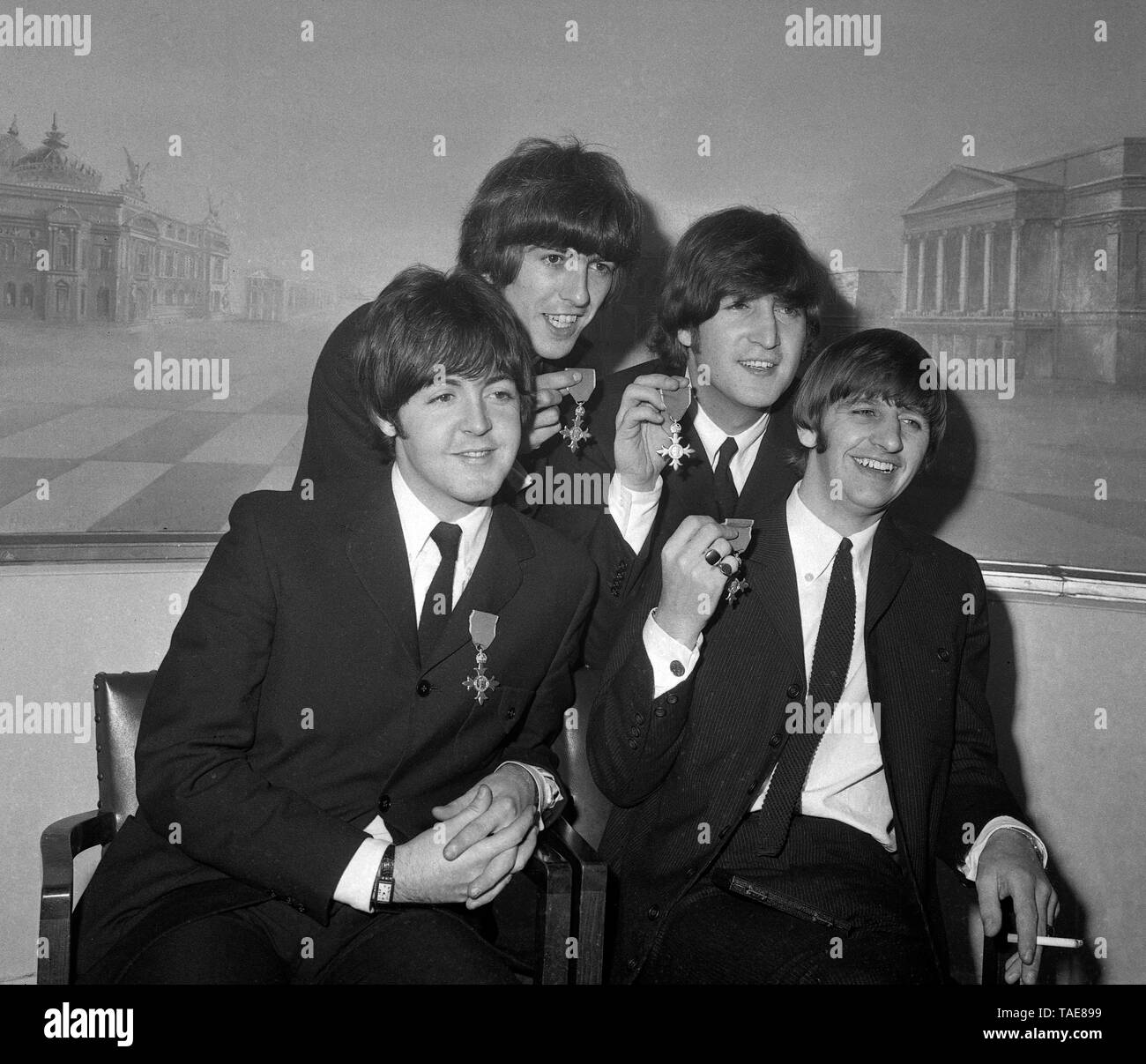 The four happy Beatles pop stars display their insignia as Members of ...