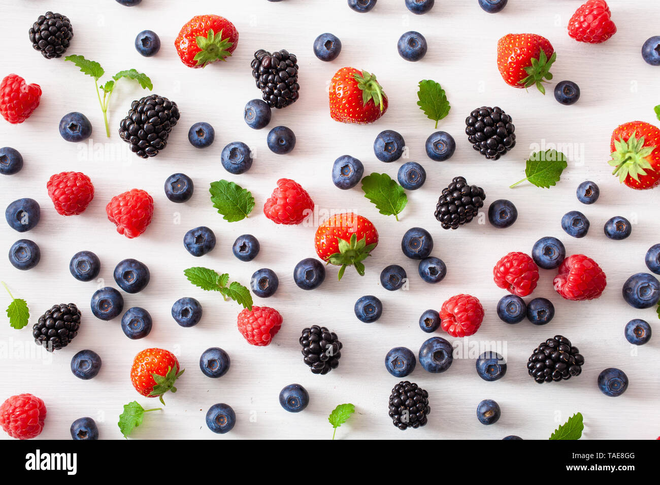 assorted berries over white background. blueberry, strawberry, raspberry, blackberry Stock Photo