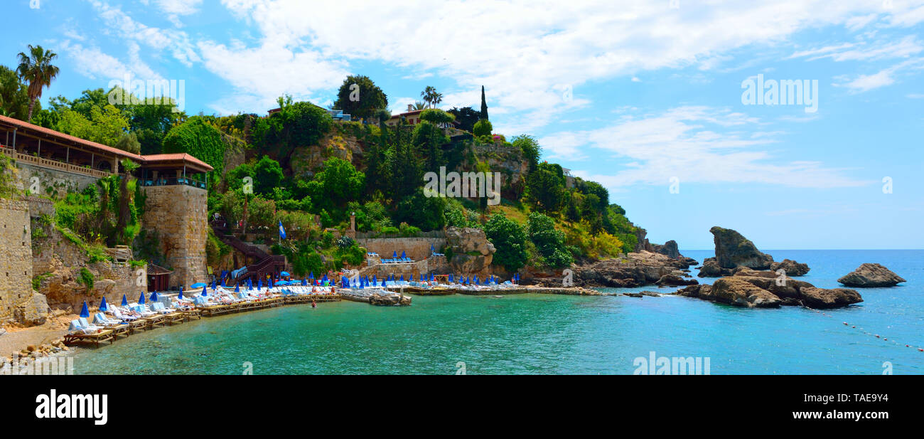 Mermerli Plaji or Mermerli beach with clear azure water in old town Kaleici district of popular seaside resort city Antalya Turkey. Panorama. Stock Photo