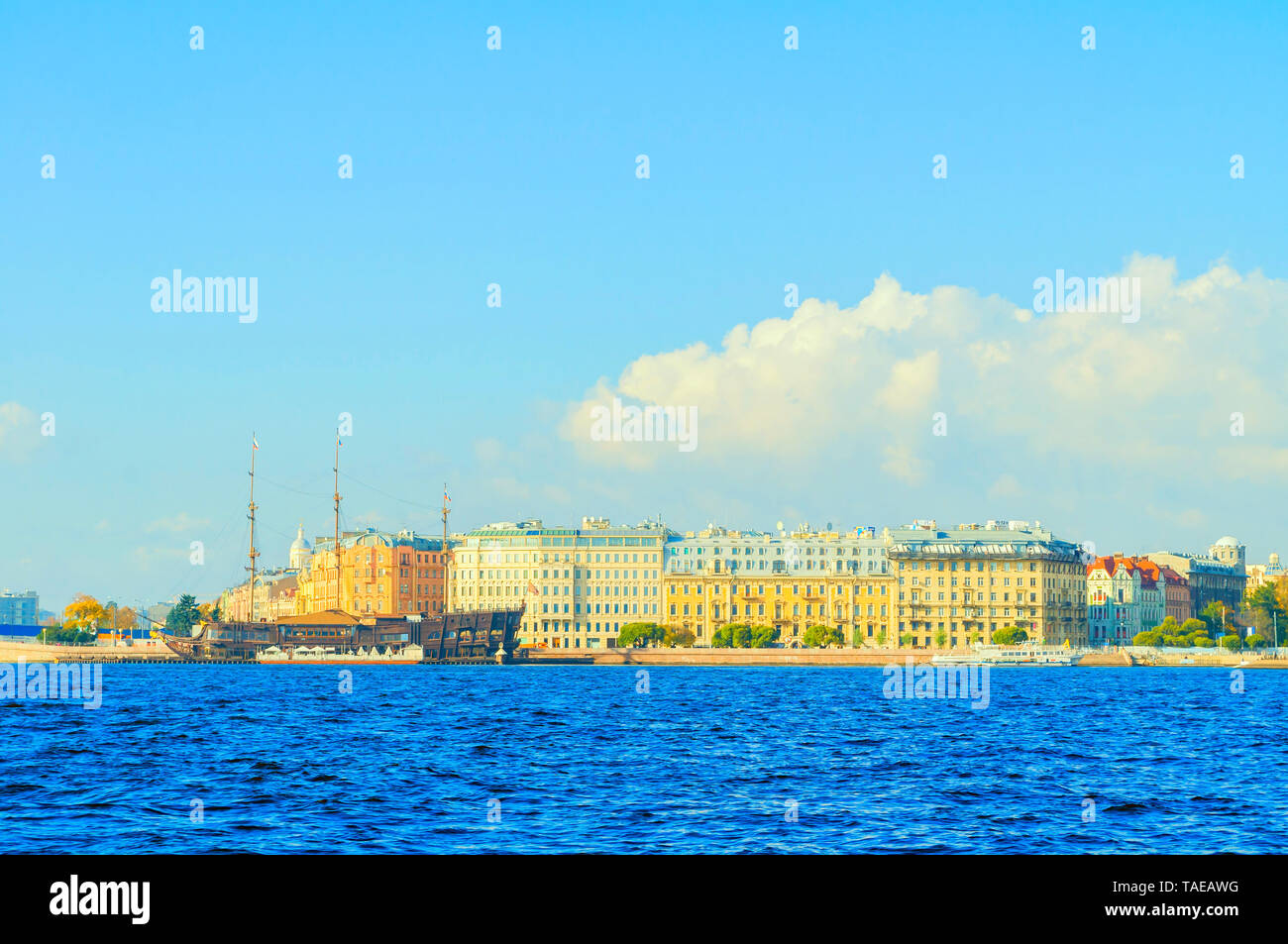 St Petersburg, Russia - October 3, 2016. Mytninskaya embankment and city buildings along the Neva river with Flying Dutchman - restaurant on the water Stock Photo