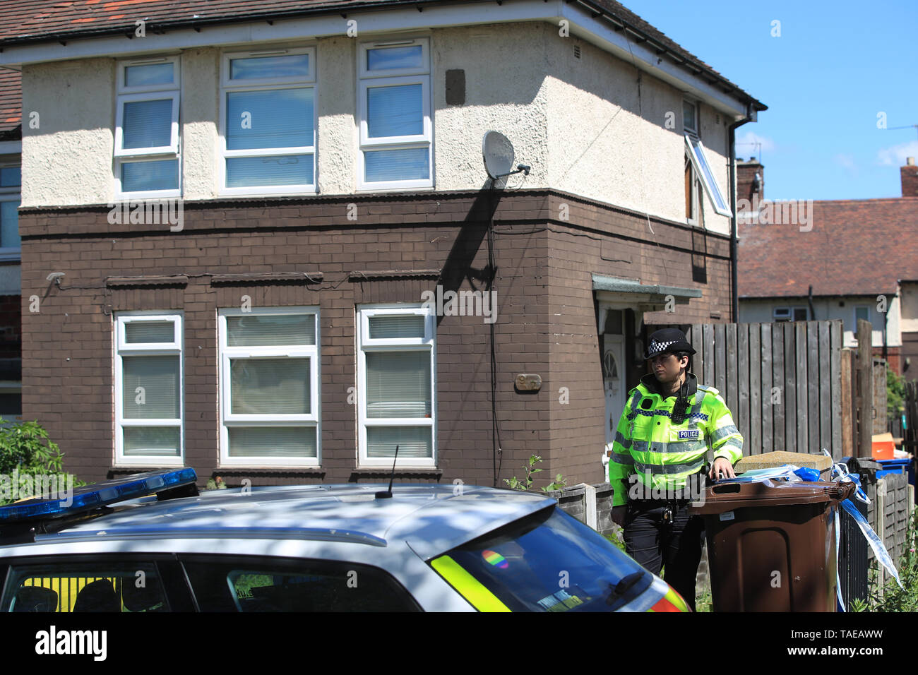 A police officer at a property on Gregg House Road in Shiregreen, Sheffield, after six children