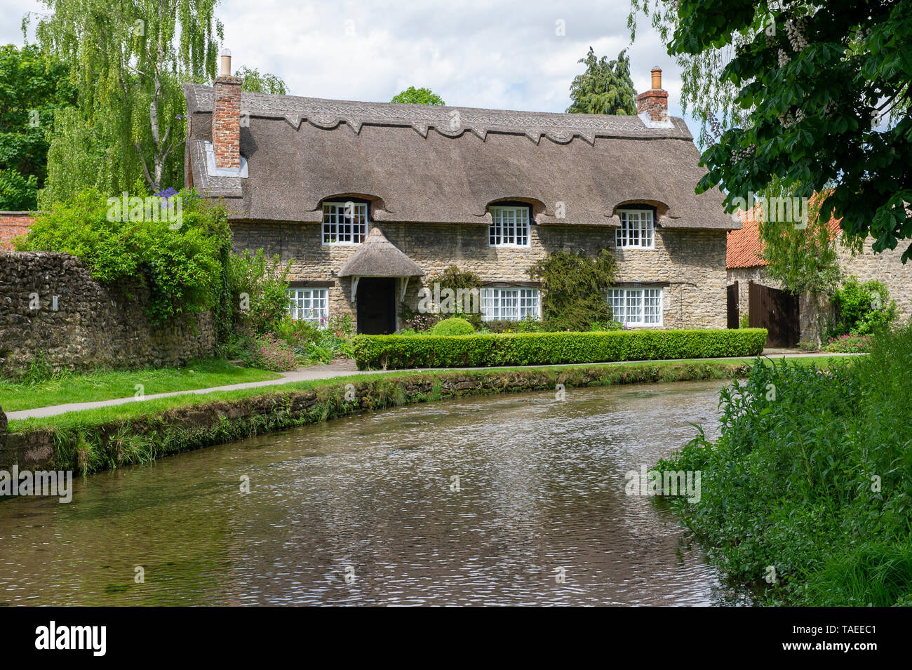 The iconic Chocolate Box Thatched Cottage in Thornton le Dale in the North York Moors National Park Stock Photo