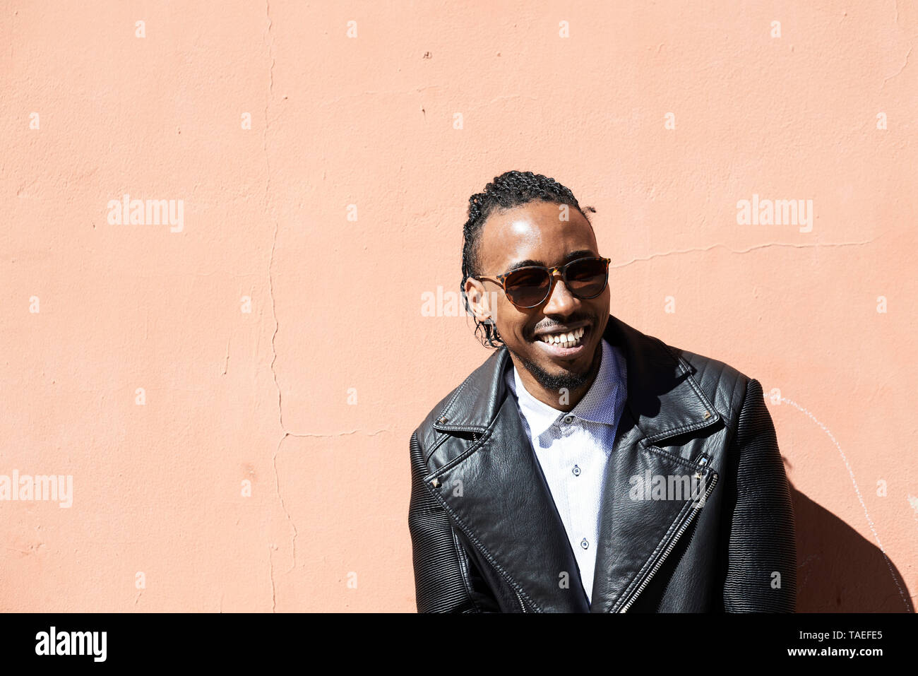 Portrait of a happy young man with sunglasses outdoors Stock Photo