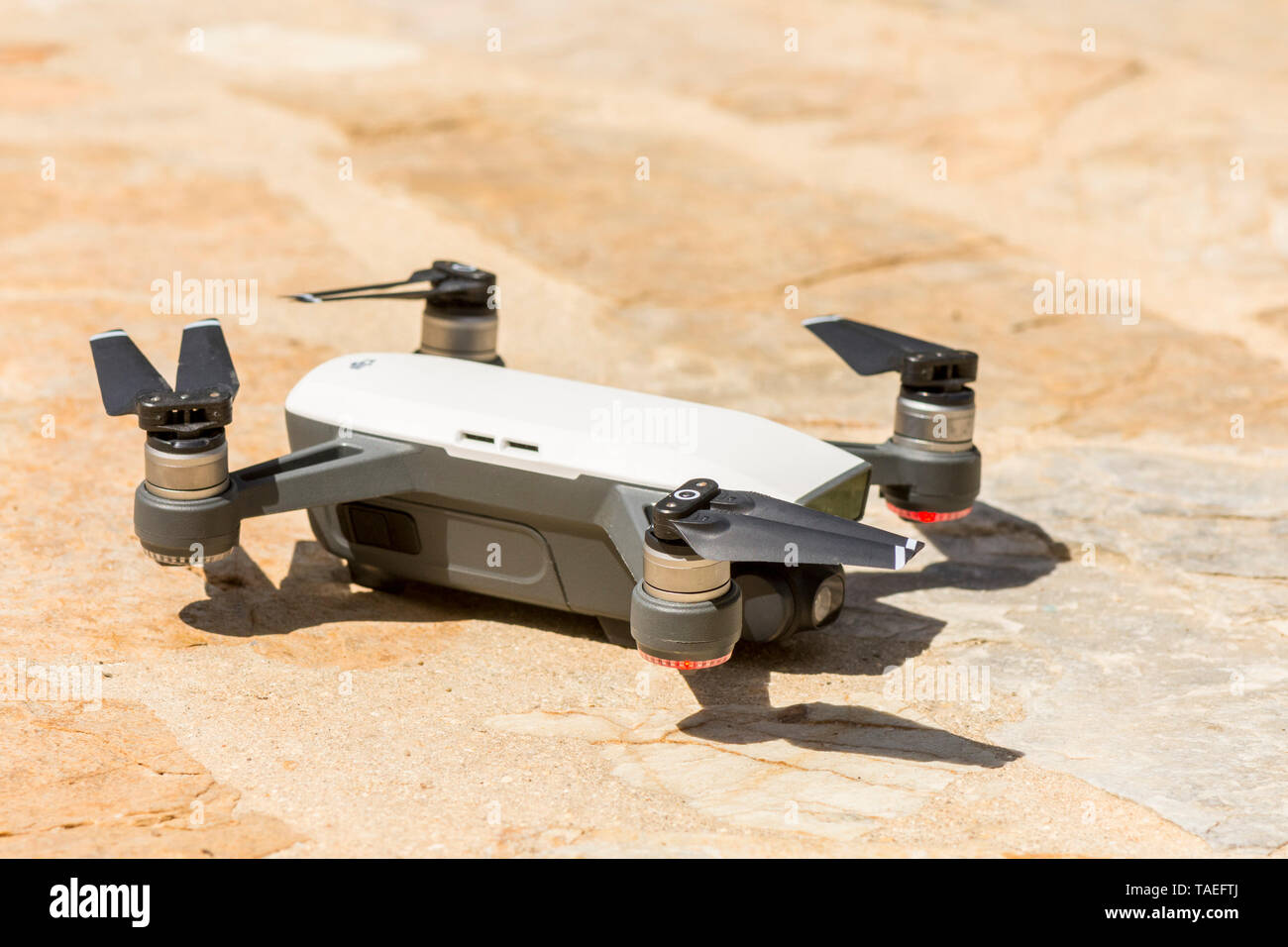 Drone copter, DJI Spark, on the ground with high resolution digital camera. Stock Photo