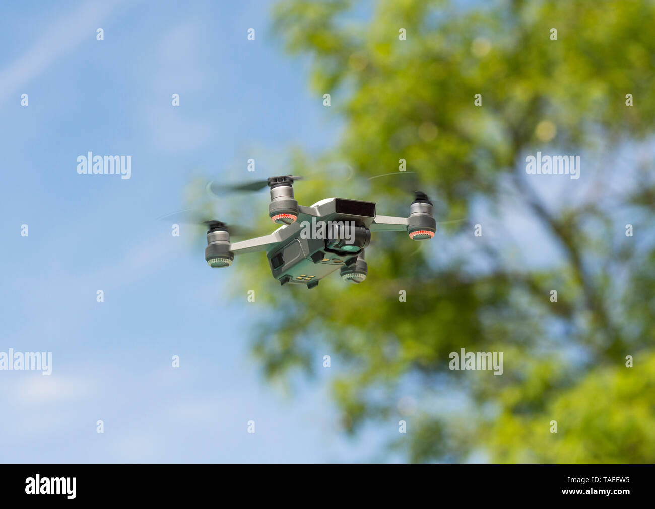 Drone copter, DJI Spark, flying with high resolution digital camera,  hovering and passing trees Stock Photo - Alamy