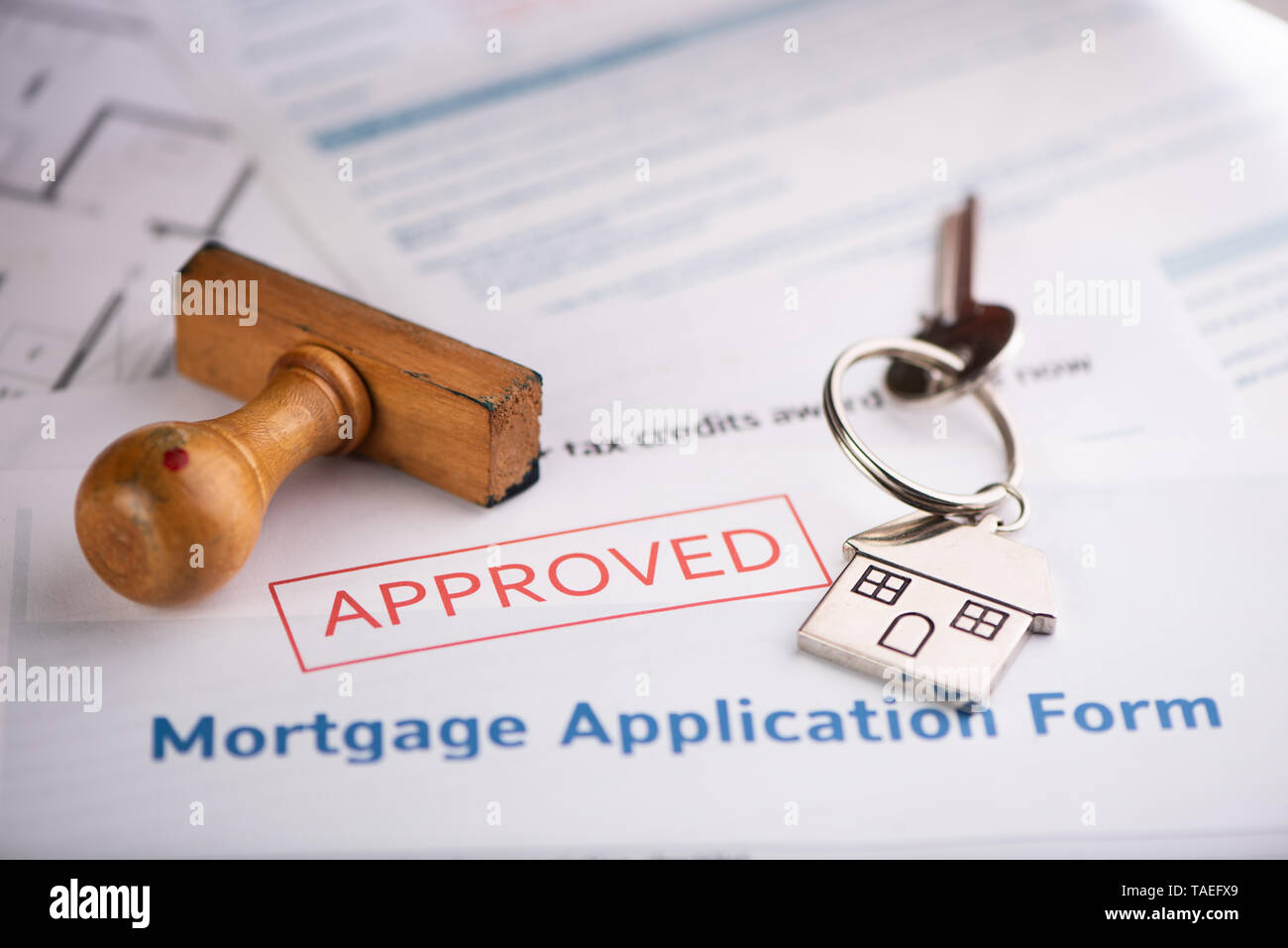 An approved Mortgage loan application form with house key and rubber
