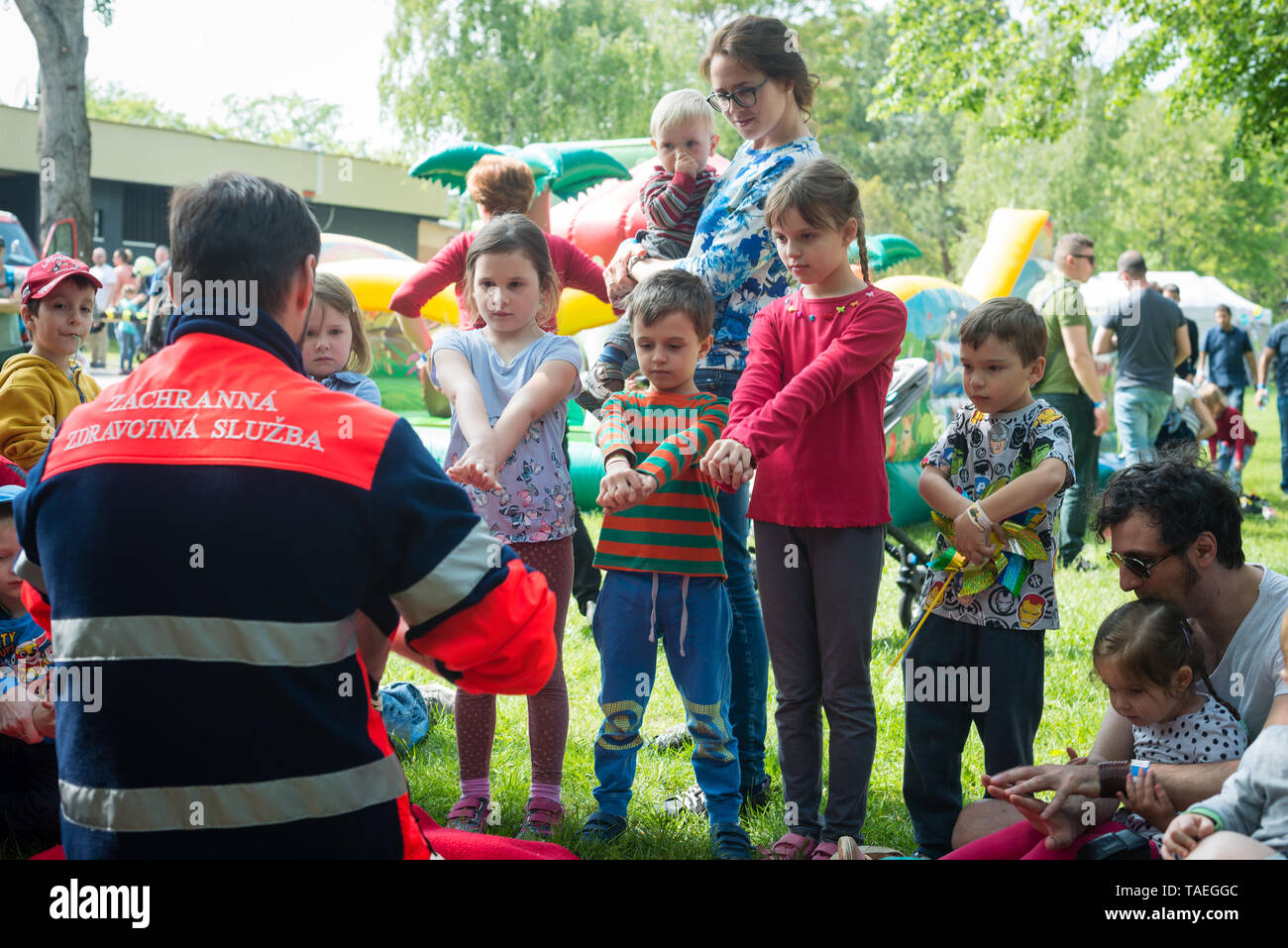 BRATISLAVA, SLOVAKIA - MAY 18, 2019: Male rescuer demonstrating CPR to kids with an emergency dummy in Bratislava, Slovakia Stock Photo