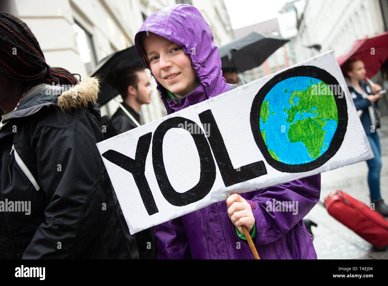 OSLO - MAY 24, 2019: A student carries a sign reading 'YOLO' (you only live once) as thousands march in the School Strike for the Climate in Oslo, Norway, May 24, 2019. Stock Photo