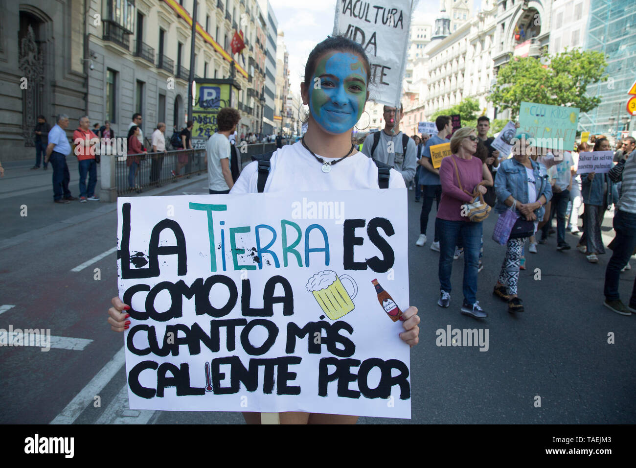 A protester with a painted face of the Earth seen holding a placard that says Spanish The Earth is like a beer, the hotter the worse during the protest. Hundreds of young Spaniards joined the international movement Fridays for Future in Madrid to protest against the climate situation and demand for measures against climate change with the principal slogan 'There is not planet B'. Stock Photo