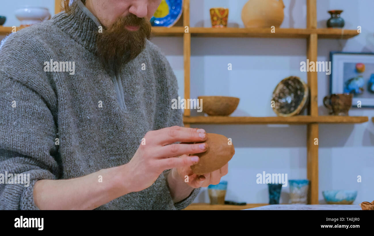 Professional male potter making mug in pottery workshop Stock Photo - Alamy