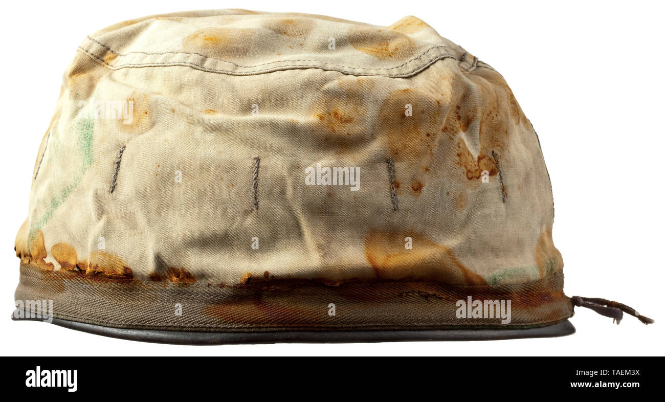 A steel helmet cover for paratroopers in splinter camouflage pattern Cover of imprinted cotton material, the exterior with splinter pattern camouflage and attachment strap for camouflage material, white interior, central size stamping "2", with strap. Obvious oxidation marks from a helmet. historic, historical, Air Force, branch of service, branches of service, armed service, armed services, military, militaria, air forces, object, objects, stills, clipping, clippings, cut out, cut-out, cut-outs, 20th century, Editorial-Use-Only Stock Photo