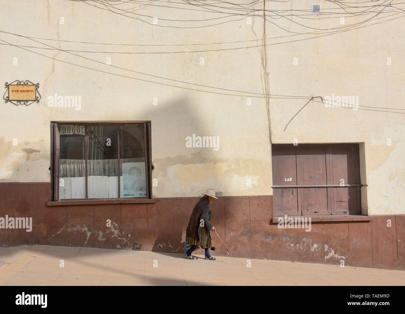 Old woman walking with a cane in colonial Potosí, Bolivia Stock Photo