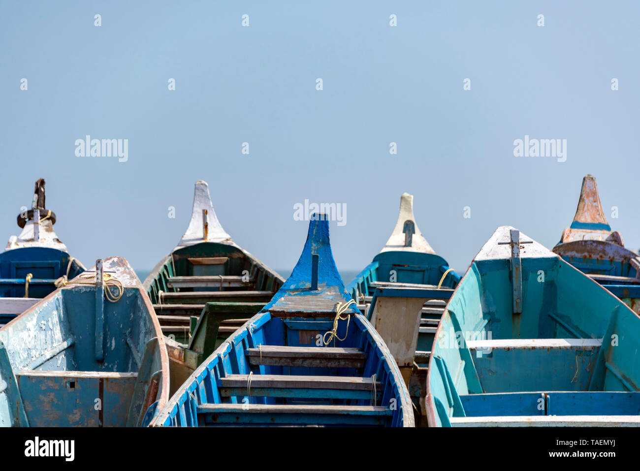 Horizontal close up of many traditional wooden fishing boat bows in India. Stock Photo