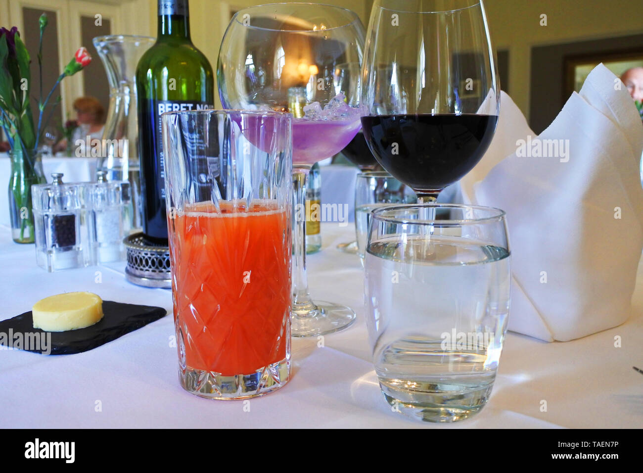 Assorted colorful drinks on a table in a restaurant - John Gollop Stock Photo