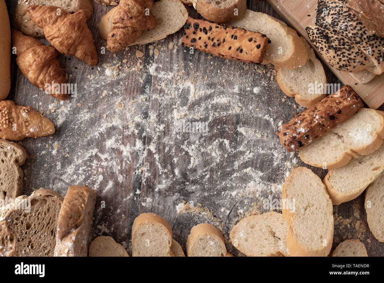 Breads and pastry flour on a wooden table and space for text input