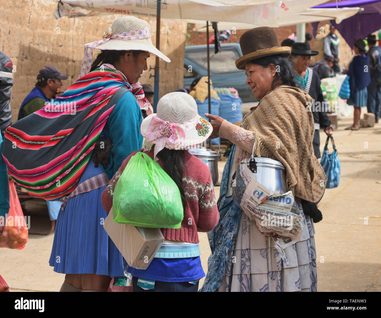 Cholita selling kitchenware at the Sunday Market, Tarabuco, Bolivia Stock Photo